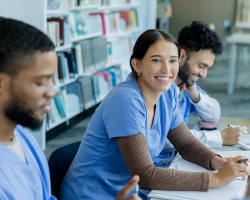 Hình ảnh về group of diverse students studying nursing and smiling in a classroom setting