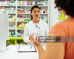 Hình ảnh về Pharmacist in a pharmacy serving a customer